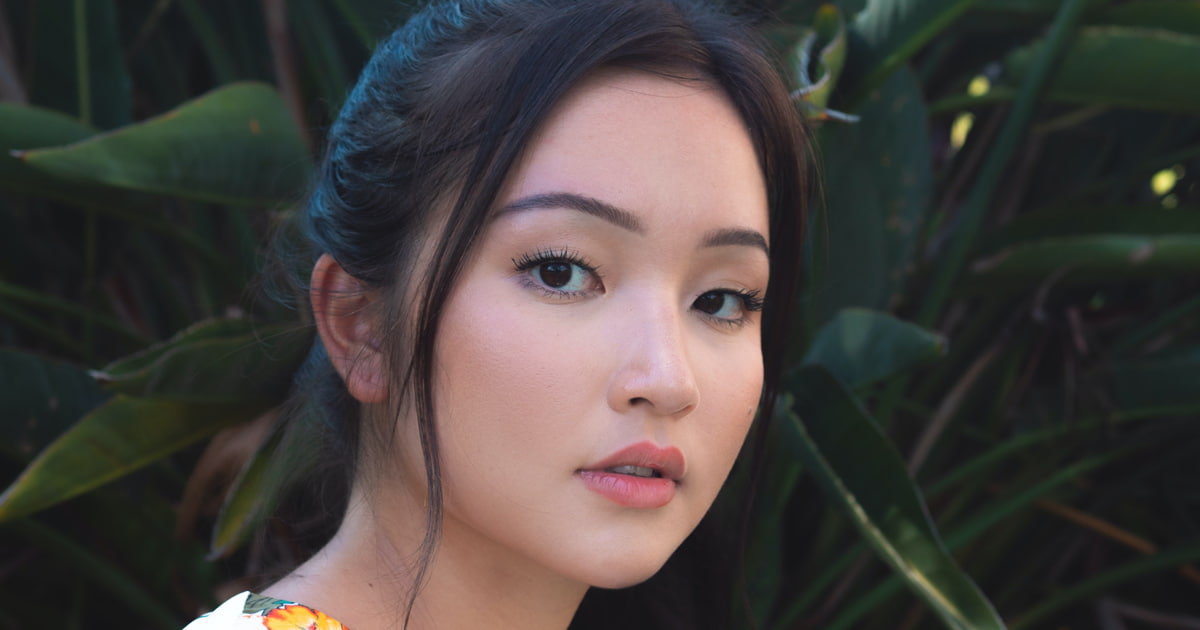 A photo of a beautiful Asian woman in a floral top