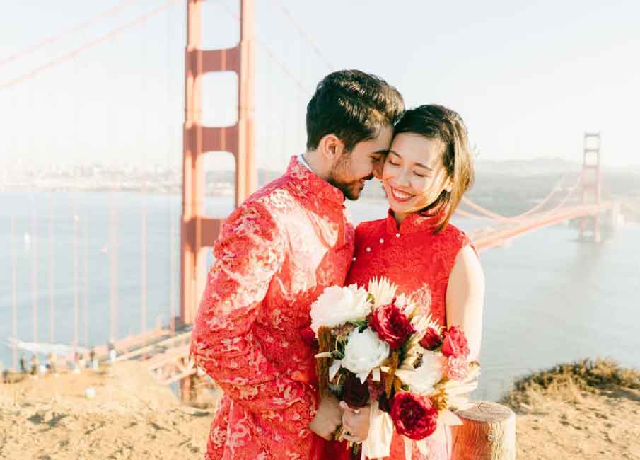 newlywed couple with bridge in the background