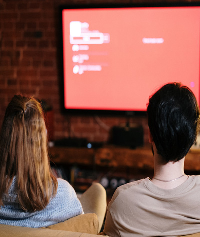 A photo of a couple sitting together on a couch during a movie date night