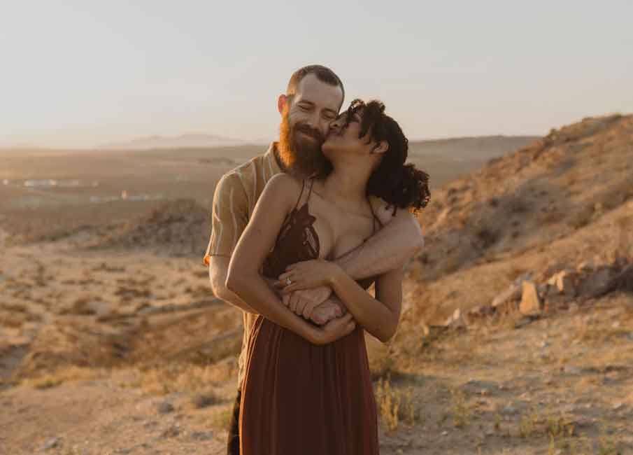 couple hugging under the sun