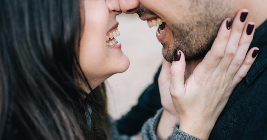 closeup of man and woman happily hugging each other