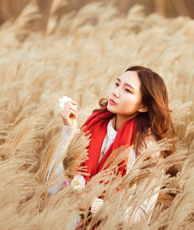 An Asian woman in a wheat field